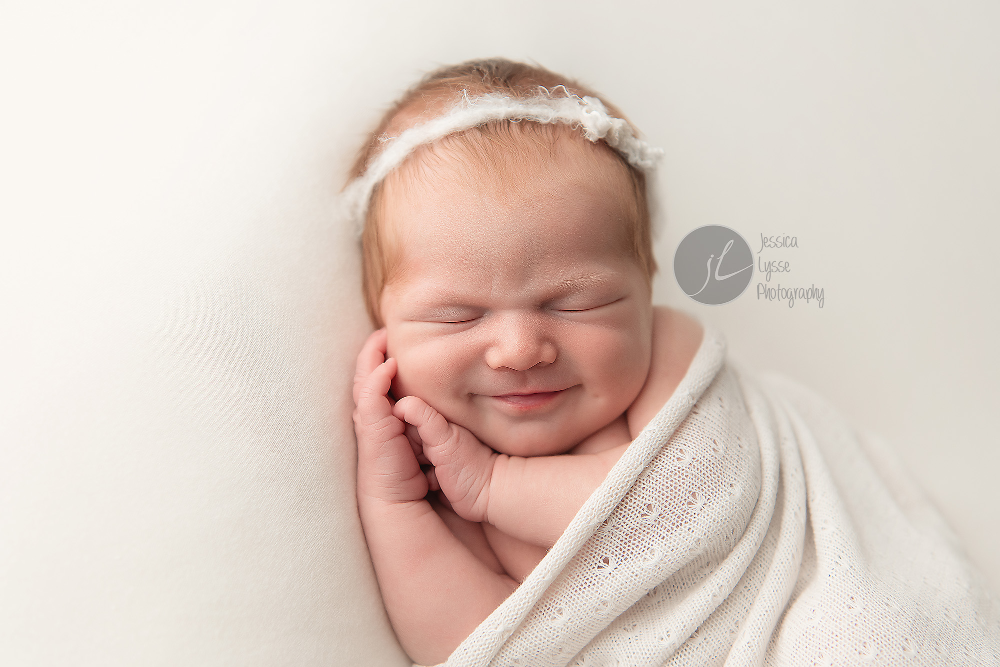smiling newborn with dimple